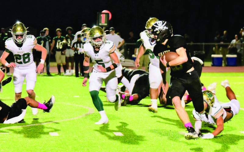 Dane Villadsen runs left on his way to a Pirate touchdown Friday against the LCM Bears. Photo by Randall Luker