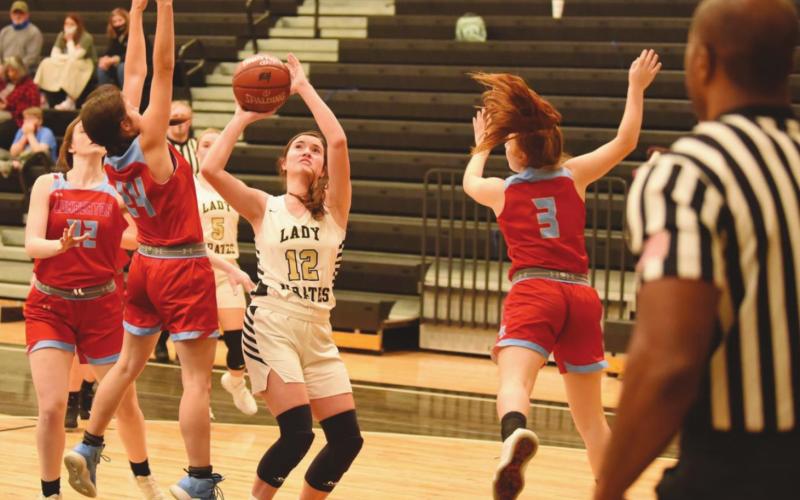 Ava Lightfoot keeps her eye on the goal as she shoots between two Lady Raiders.