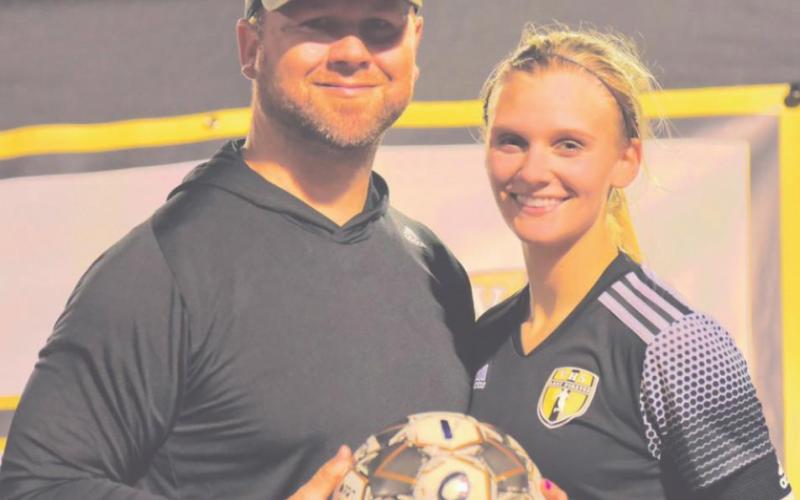Brooklyn Healy with Coach Ralph Fields after scoring her 100th career goal.