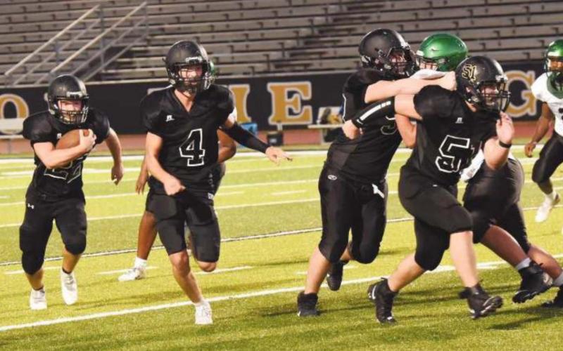 JV RB Caleb Dean bursts out of the backfield as #4 Ricky Gall, #50 Brooklyn Freeman, and #51 Jesse Meyers get out front to block.