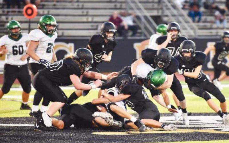 As this defensive swarm illustrates, the JV Pirates dominated both sides of the line Thursday as they defeated the Livingston Lions 28-0.