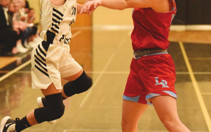 Taylor Waguespack take a shot over a Lumberton Lady Raider in the Lady Pirates final game of 2019. Saturday, the Lady Pirates host the Lady Cougars of Buna at Pirate Gym to kick off 2021 competition.