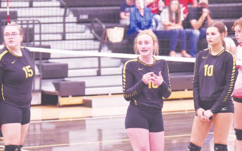 Lady Pirate junior varsity players 15-Ashlee Malagarie, 16-Natalie Morrison and 10-Andreya Garrett look to the sidelines during a break in the action Friday night versus Deweyville.