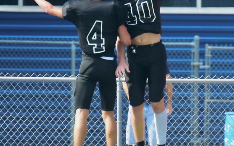 Freshman Pirates Caden Beavers #40 and Cade Safer #4, celebrate in the end zone after scoring a touchdown in last week’s scrimmage with WOS. Photos by Randall Luker