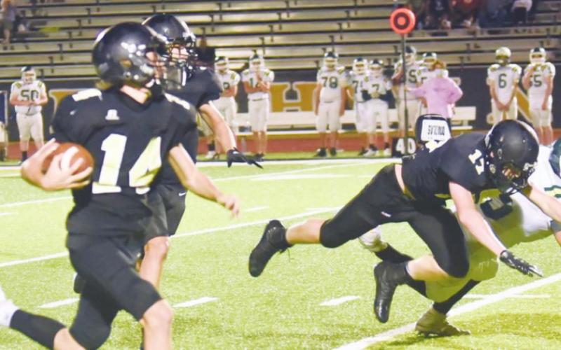 Hayden Landry, #14, finds plenty of running room as Grant McWherter, #17, blocks a LCM Bear Thursday at Pirate Stadium. Photo by Randall Luker