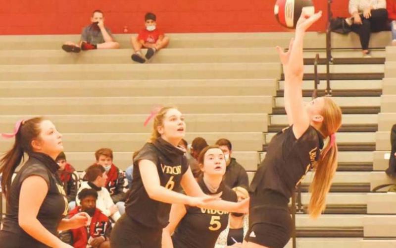 Brooklyn Healy sets the ball as Claire Villadsen, Brooklyn Bushelle and Ava Lightfoot move up for a hit.
