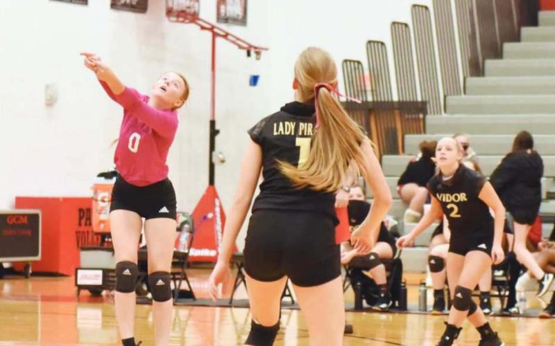 Skyler Head, #0, sets a deep-hit ball as #1 Brooklyn Healy and #2 Ella Bunting keep an eye on the ball.