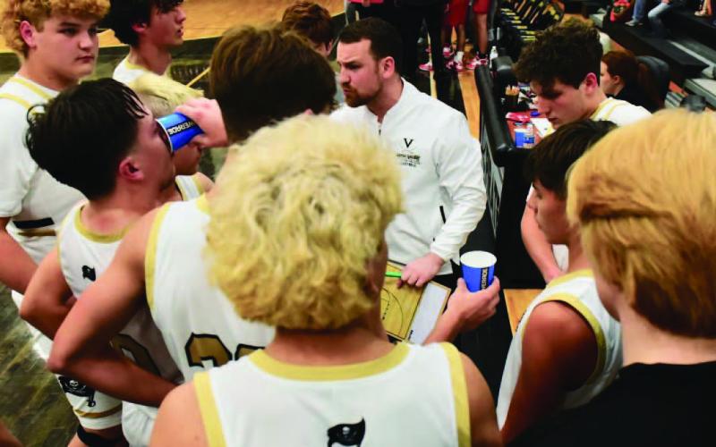 Varsity boys basketball coach Joseph Hoyt talks strategy during a timeout. File Photos