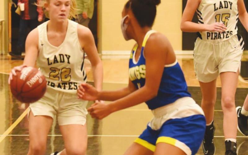 Jaelyn Justice maneuvers for a shot as Madison Powell and Natalie Morrison move toward their positions.