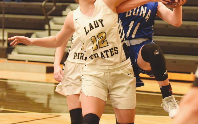 Ava Lightfoot blocks a Lady Cougar’s shot in Saturday’s game at Pirate Gym.