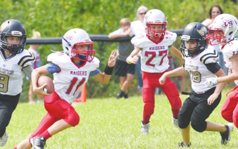Junior White defenders #9 Karaon Cudd and #18 Carlos Gutierrez pressure the Lumberton QB in Saturday action.