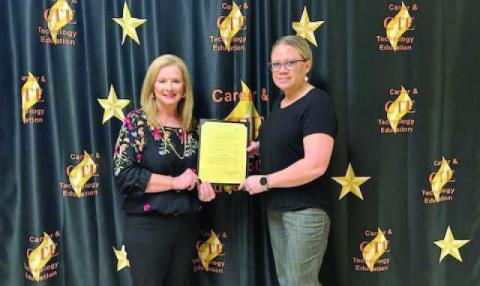Pictured is Mayor Misty Hart presenting CTE Director Penny Singleton with a signed Proclamation Document