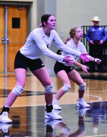 Varsity Lady Pirates Madison Powell, left, and Mia Robin await a Silsbee Lady Tiger serve Friday. Photo by Randall Luker