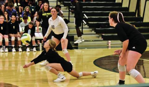 Mia Robin gets a dig versus LCM last week as #10 Carlie Abbott and Rylee Sherman look on. Photos by Randall Luker