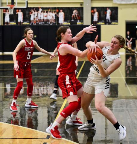 Natalie Morrison fights to retain possession of the ball versus Bridge City. Photo by Randall Luker