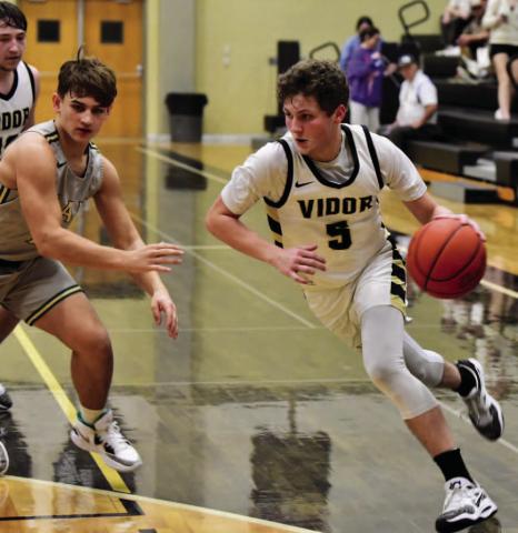 Bryce Loftin drives on the basket in Friday district game versus LCM. Photo by Randall Luker