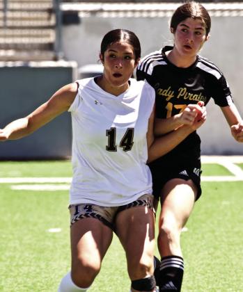 Eyes on the Ball Lady Pirate Jordyn Fowler and a Giddings Lady Buff concentrate on the ball as they await a throw in.