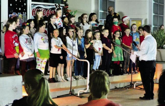 Pine Forest Elementary fourth grade choir students provided entertainment at the tree lighting event with a selection of favorite carols. Photo by Randall Luker