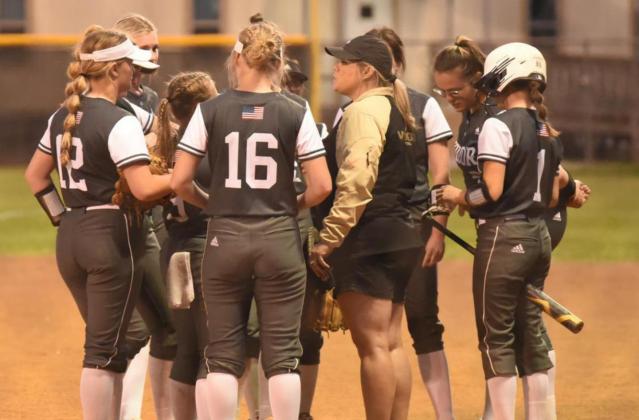 Coach Nikki Trahan talks things over with the Lady Pirates between innings at Friday’s Bridge City game. Photo by Randall Luker