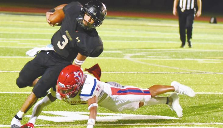 Pirate quarterback Quinten Root avoids a tackle as he cuts upfield against the Brazosport Exporters Friday.