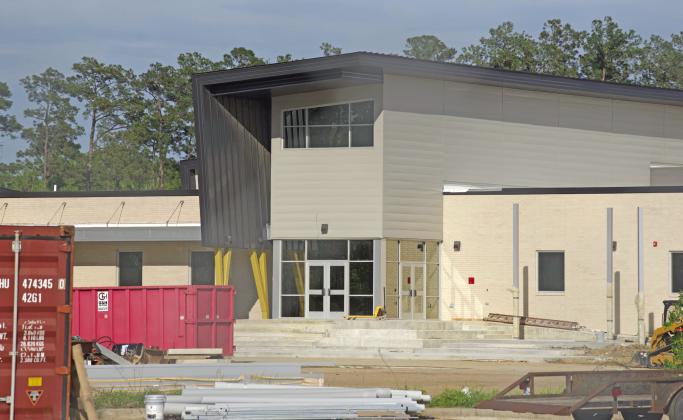 Workers have been installing metal awnings over sidewalks and at entranceways at Vidor Middle School as the final stages of construction are in full swing. The VISD plans a Community Open House at the new facility May 2.