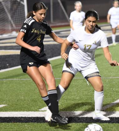 Lady Pirate Kenya Correia maneuvers the ball near the sideline as a Lady Bulldog competes for possession. Photo by Randall Luker