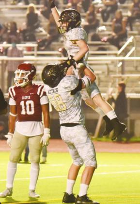 Caiden Veazey hoists Weston Sepulvado into the air after he scored a second half touchdown.