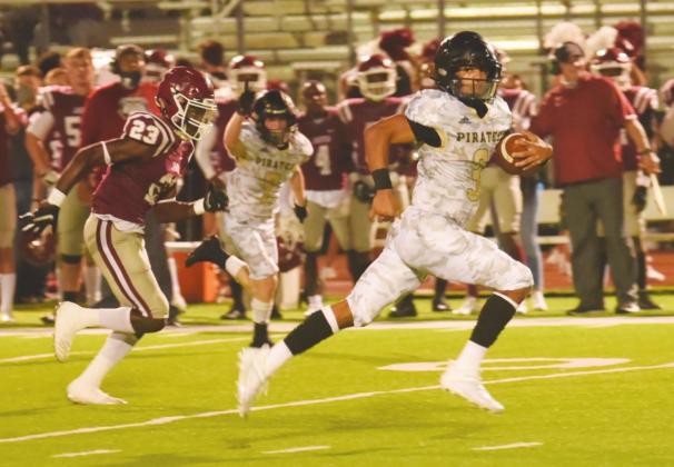 Pirate QB Quinten Root crosses midfield as he outruns his pursuers as he heads for a Pirate touchdown.