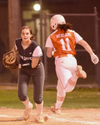 An Orangefiled runner couldn’t beat the throw to first baseman Brooklyn Bushelle in Friday’s district game in Orangefield. Photo by Randall Luker