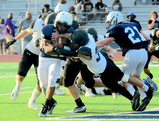 Aiden Villafano stretches to bring down a WOS Mustang runner in Wednesday’s scrimmage.