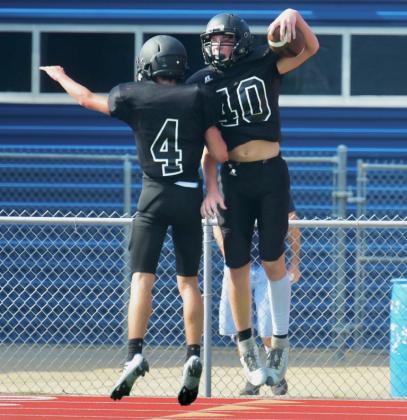 Freshman Pirates Caden Beavers #40 and Cade Safer #4, celebrate in the end zone after scoring a touchdown in last week’s scrimmage with WOS. Photos by Randall Luker