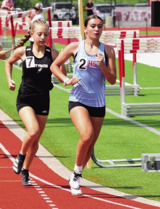 Mia Robin, left, qualified for REgionls in the 800m run. Photo by Randall Luker