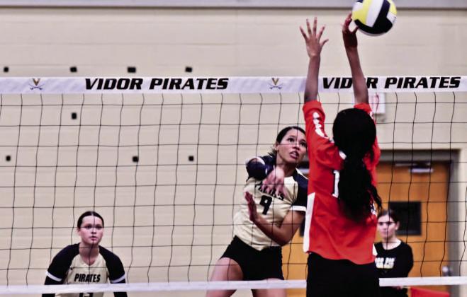 Madison Jones gets an overhand return past a Lady Titan Tuesday in Pirate Gym. Photo by Randall Luker