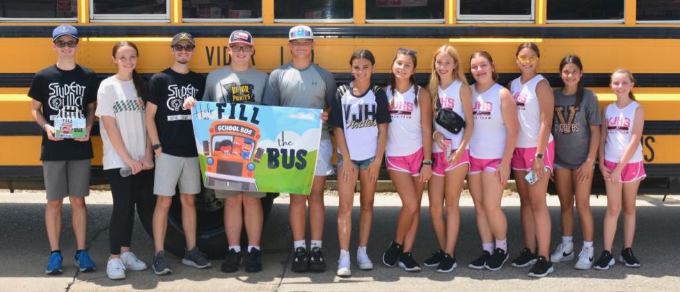 These students collected donations and put away supplies during the second shift of the Fill the Bus event Saturday. Photo by Randall Luker