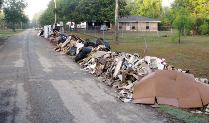 After paying with more than $10 million in local tax dollars for Hurricane Harvey Storm Debris removal for the last ten months, FEMA has agreed to reimburse Orange County soon for its efforts to pick up debris piles like this one in Pine Forest. Archive Photo