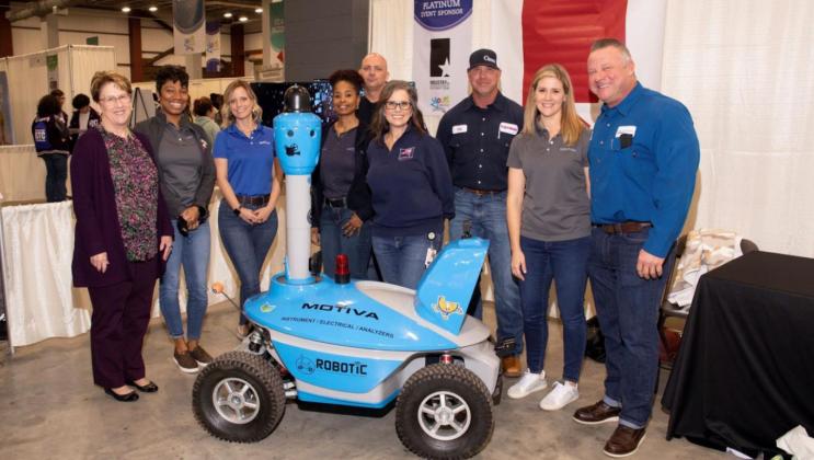 Platinum sponsor Industry of Southeast Texas representatives showcase robotic equipment used for student demonstrations.