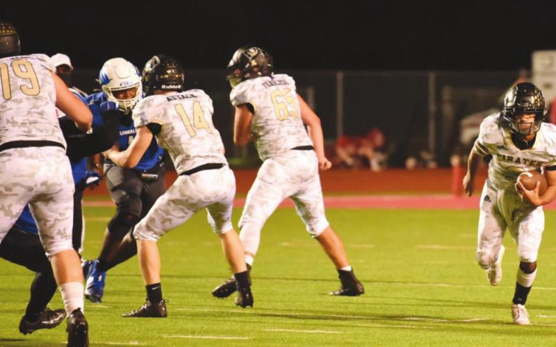Pirate QB Quinten Root runs for a first down behind a screen of blockers, #79 Tyler Webb, #14 Jason Watson and #65 Bryce Munoz.