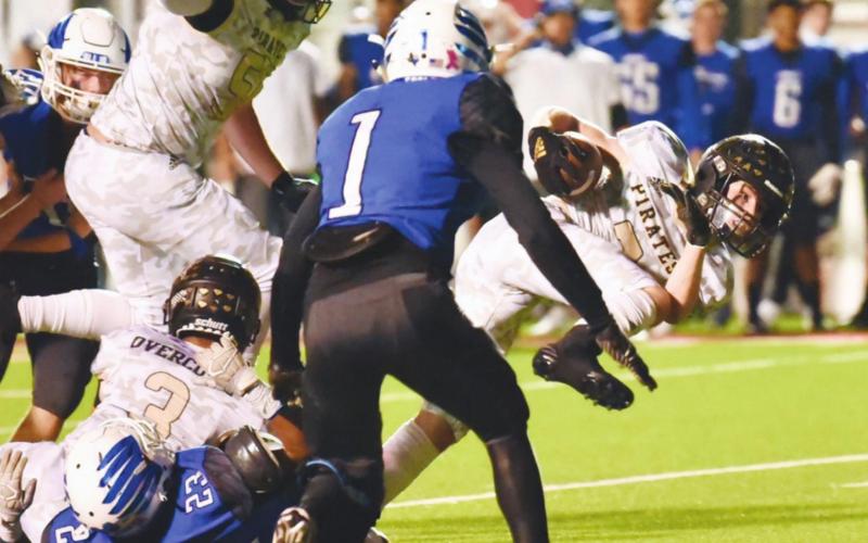 Pirate RB Weston Sepulvado powers his way through the line for plus yardage.