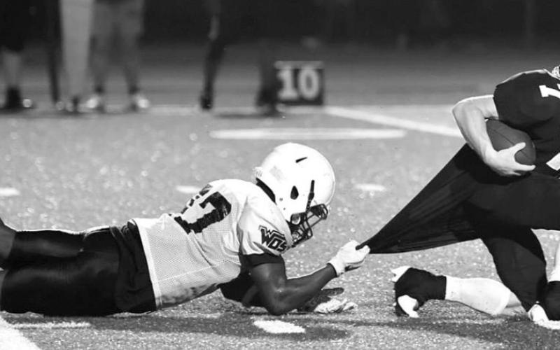 Pirate back Weston Sepulvado is stopped inside the 20 by a Mustang defender Thursday, but the Pirates capitalized on the drive with a complete pass for a TD in the front corner of the end zone. Photo by Randall Luker