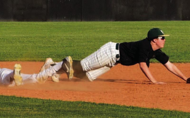 Alex Parish, diving headfirst into second base, is safe after a throwing error. The junior varsity defeated the LCM Bears in Vidor. Photos by Randall Luker
