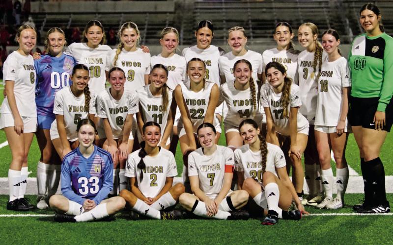 The 2025 Vidor Lady Pirate Soccer team gathers on the field for their team photo following the Regional match.
