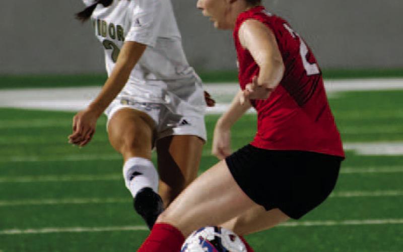 Taylor Bull kicks through the Salado defender’s legs as the Lady Pirates move the ball on offense.