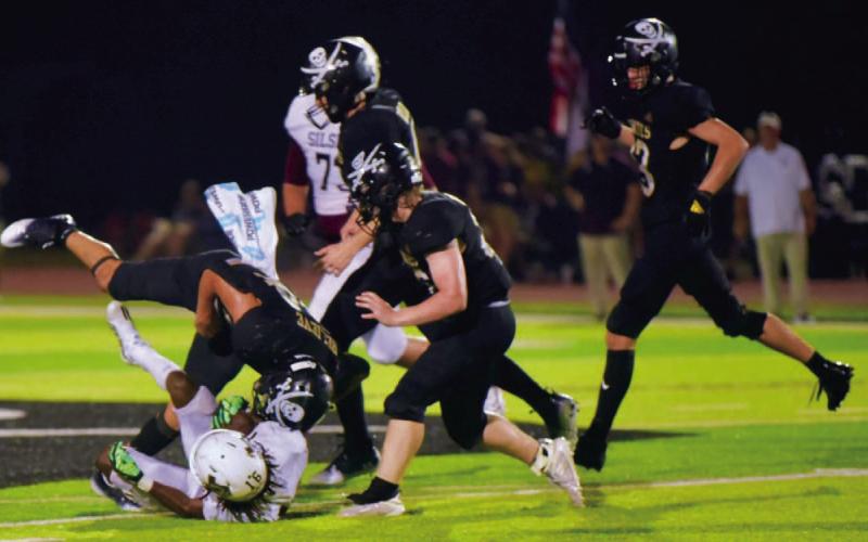 Pirate QB Jarrett Odom is one of several Pirates going both ways this year, Here, he puts a Silsbee runner on his back from his free safety position.