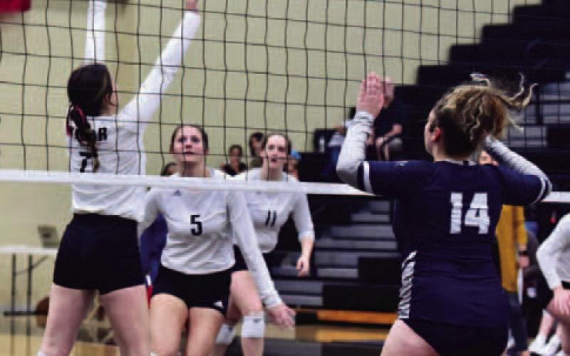 Brilie Cornelison #7 sets the ball for Madison Powell #5 in the Lady Pirates home district opener versus WOS.  Photo by Randall Luker