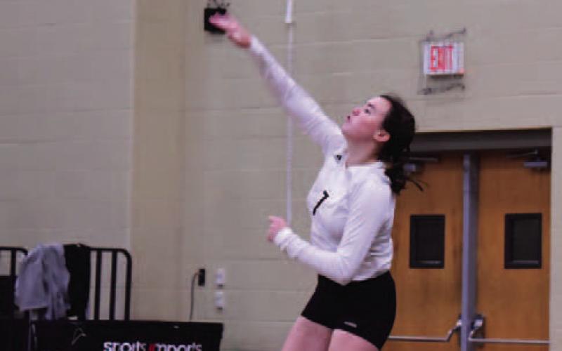 Brilie Cornelison serves to WOS in the Lady Pirates district opener  Photo by Randall Luker