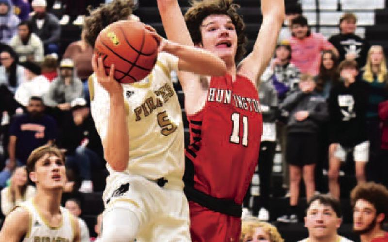 Bryce Loftin is fouled by a Huntington Red Devil as he shoots in Friday’s non-district home game. Photo by Randall Luker