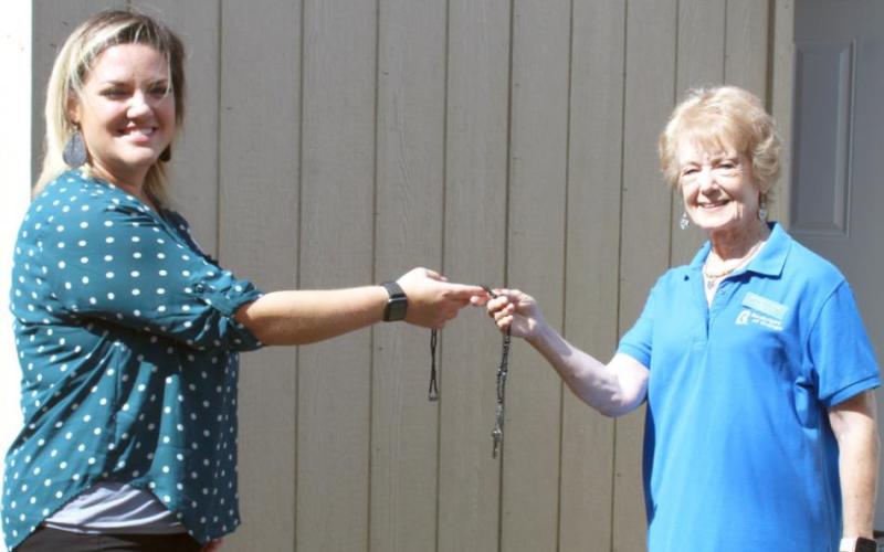 Laura Roberts, Team Leader of Leadership Southeast Texas Orange County Team #1 presents the key to a new storage building to Clara Fults, Assistant Director at Birthright of Orange.