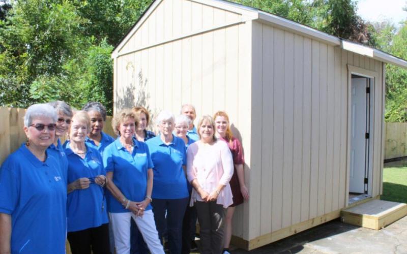 Birthright of Orange volunteers, board members, and staff pose for a photo in front of the non-profit’s new storage building. Leadership Southeast Texas organized the project, which was funded by Pecan Acres Baptist Church and Wellspring Credit Union.