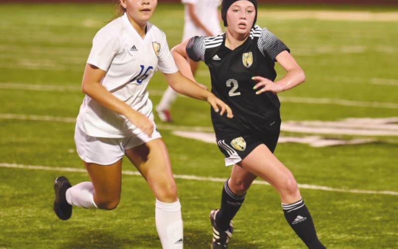 Lady Pirate Sabrey Eaves races a Blackcat for possession in last Tuesday’s playoff game in Santa Fe.