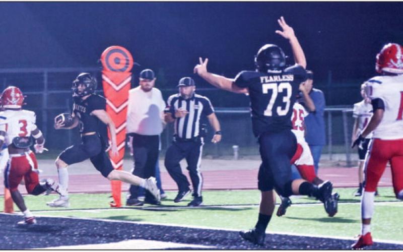 Dane Villadsen crosses the goal line for a Pirate touchdown as Jay Wright cheers him on. Photo by Randall Luker